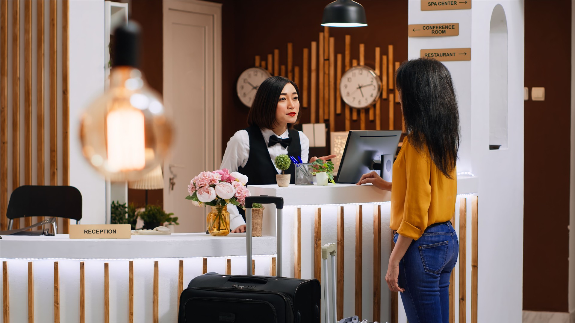 Asian staff doing check in process for new customer