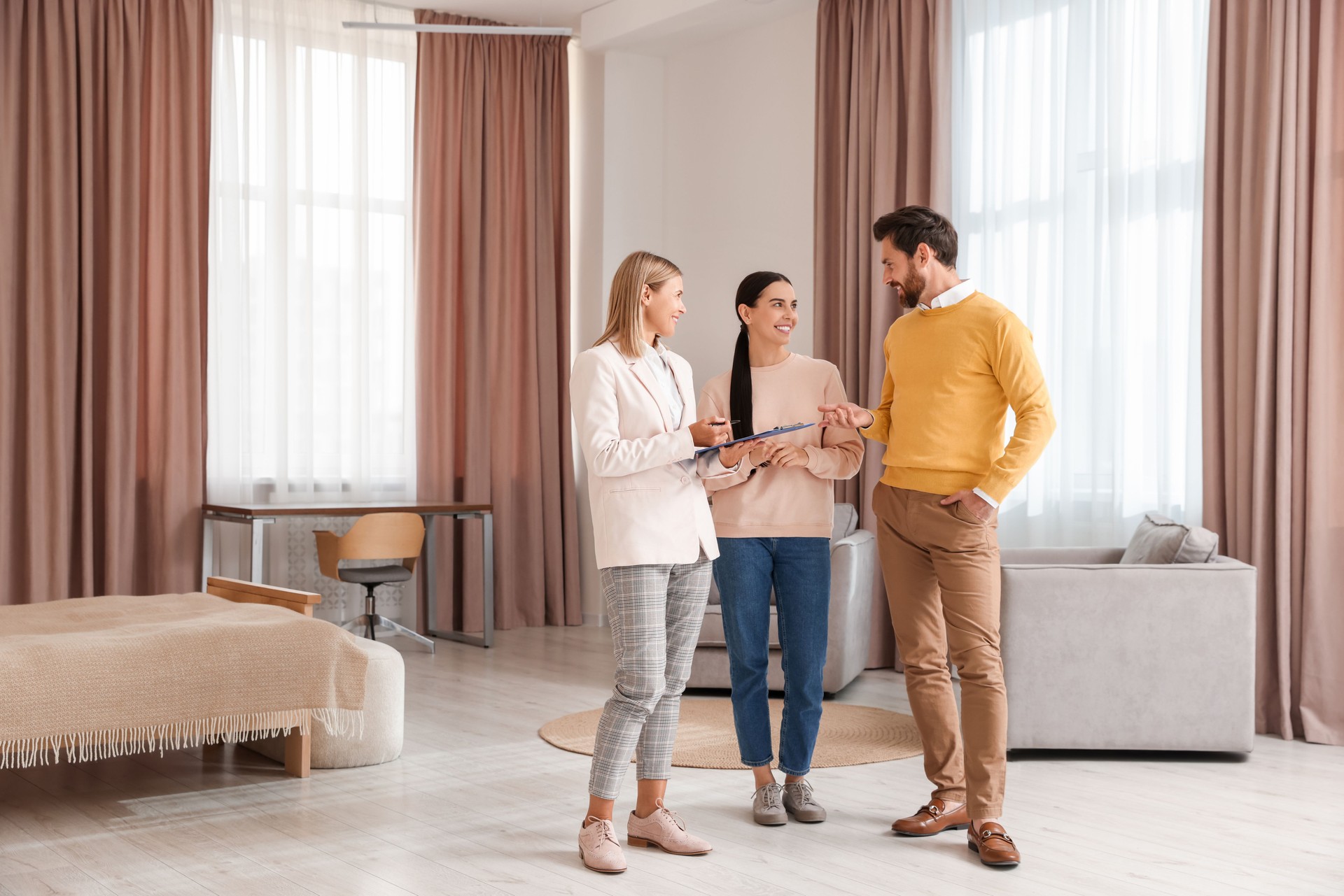 Real estate agent working with couple in new apartment